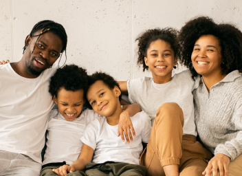 foster family with two children sitting on couch